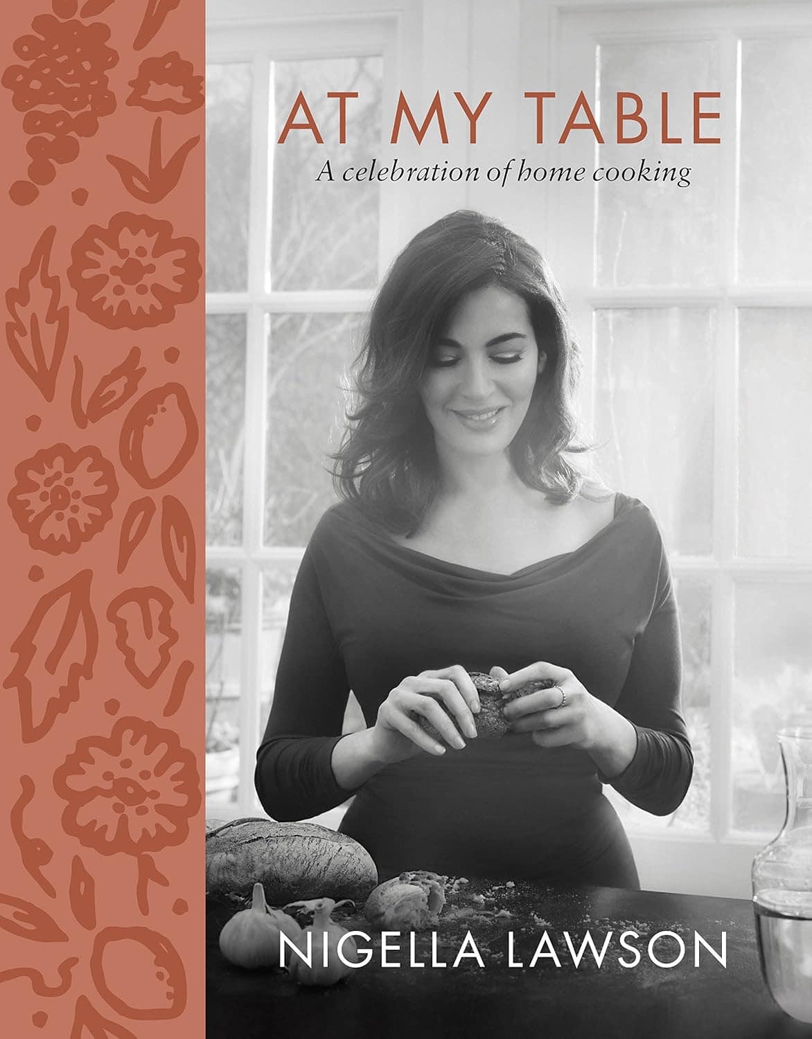 Book cover featuring a black-and-white photo of Nigella Lawson breaking a loaf of bread
