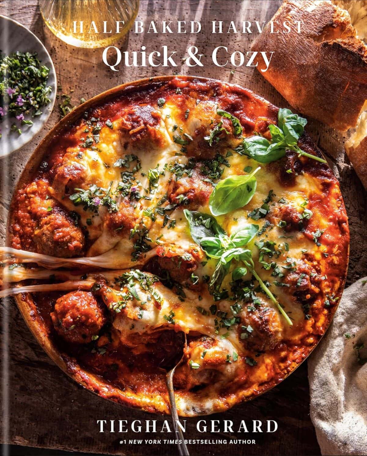 Book cover showing a serving dish of meatballs in tomato sauce covered in cheese
